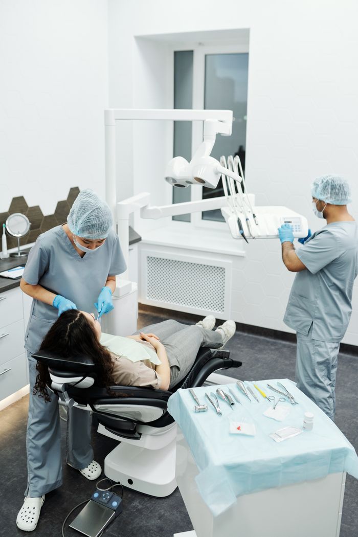 Modern dental clinic scene with a dentist examining a patient in a clean environment.